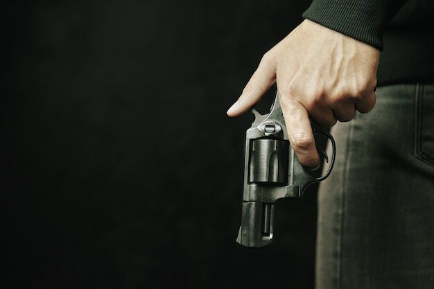 guy-with-gun-down-black-revolver-with-drum-in-mans-hand-armed-person-on-dark-background-firearms-for_72464-1717