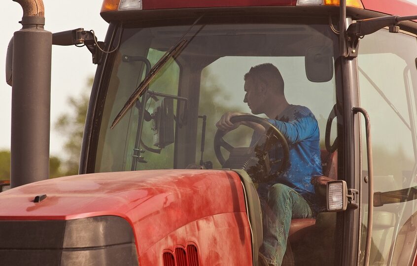 CU of farmer in tractor cab